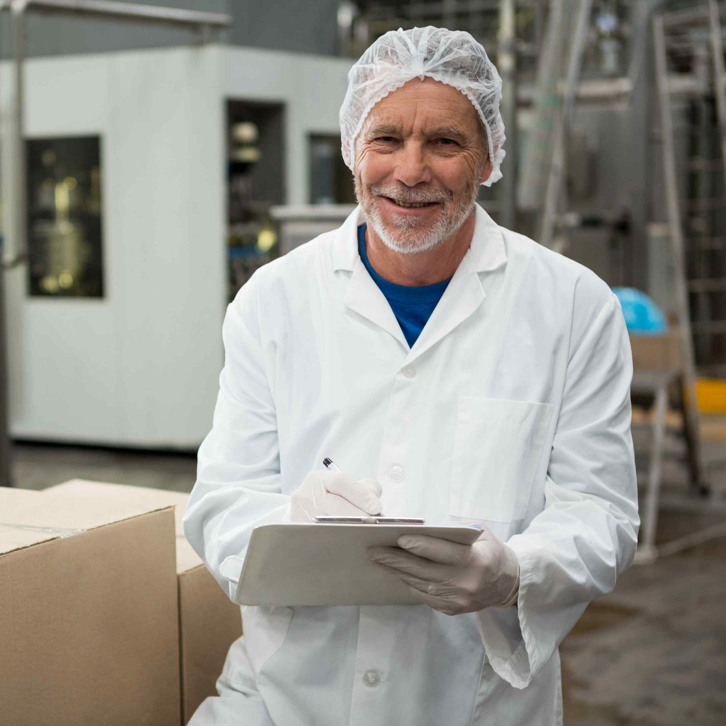 male-worker-writing-notepad-cold-drink-factory.jpg